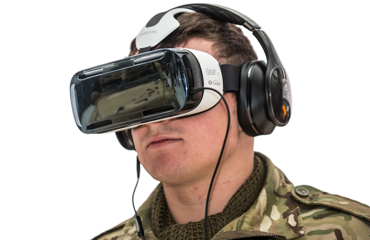 Solider wearing a VR headset and headphones for an immersive experience.