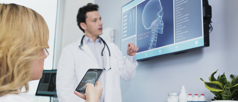 patient with tablet doctor with digital display