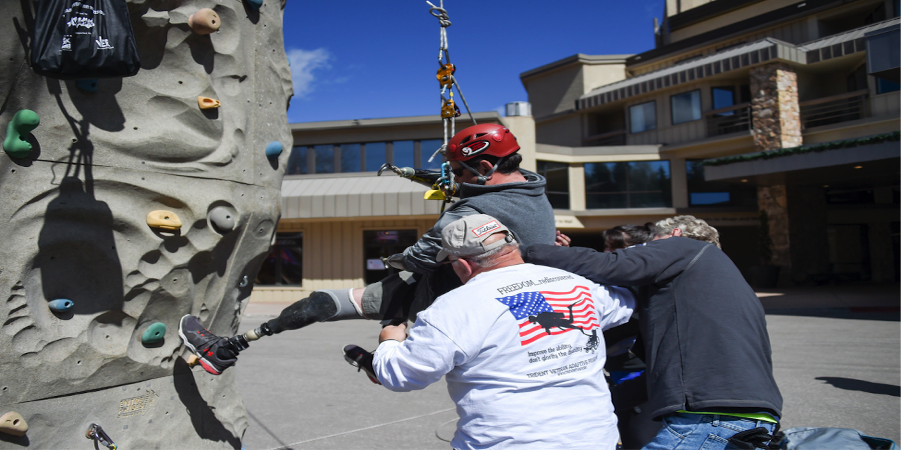 Disabled veteran climbing a rock wall.