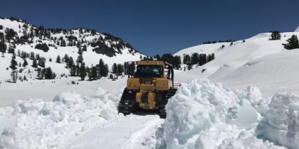 Bulldozer plowing snow in the national park