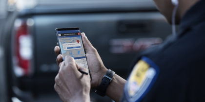 Police office enters data on Samsung smartphone