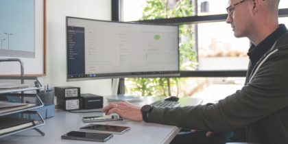 Remote worker at desk with various internet of things devices