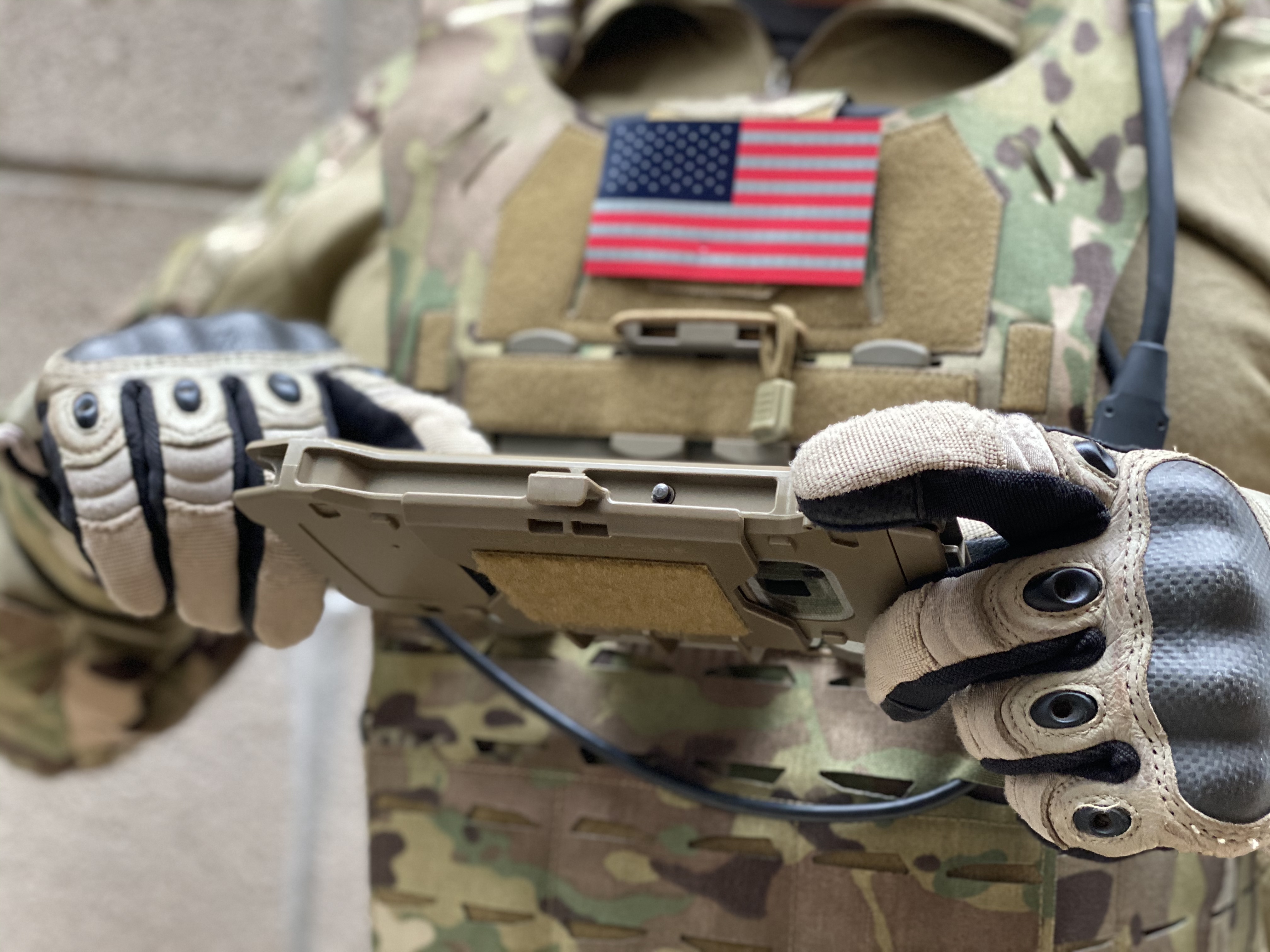 A U.S. soldier in uniform uses a Samsung Galaxy Tactical Edition