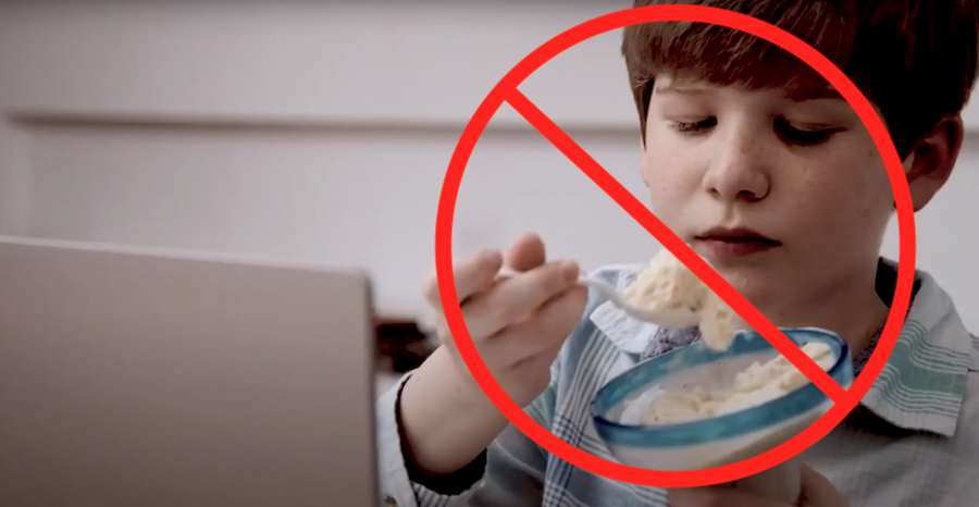 Student eating bowl of mashed potatoes over Chromebook, with prohibition symbol overlay