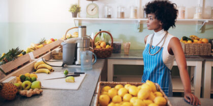 small business owner gazing out the window of her smoothie shop