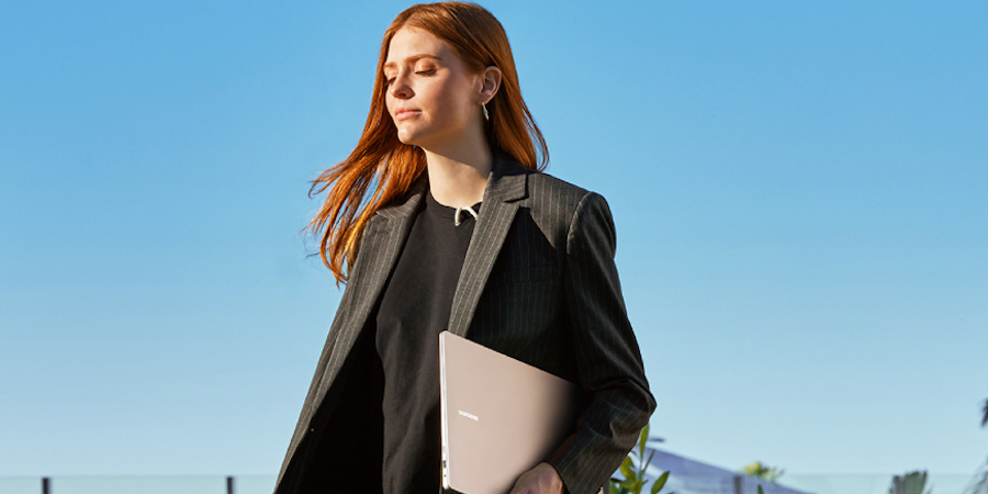 Woman holding a Samsung Galaxy Book 3