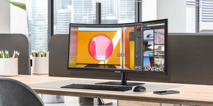 A Samsung ViewFinity S6 S65UC 21:9 ultrawide curved monitor on a modern office desk, demonstrating screen resolution comparisons for FHD, QHD, and UWQHD workflows.